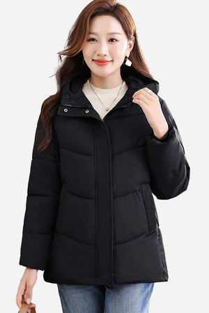 Woman wearing black Everyday Warmth Coat mid-length hooded winter jacket