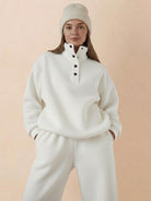 Woman wearing Warm & Easy Two-Piece Set in white, featuring a relaxed fit pullover hoodie and matching pants with a soft, warm fabric.