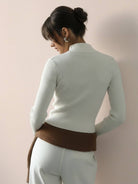 Black zip-up knit cardigan jacket with vertical ribbing and high neckline