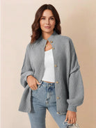 Oversized button-front knit cardigan with balloon sleeves and gold-tone buttons in chunky knit texture
