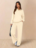 Wrinkle-free casual two-piece polo set with quarter-button top and high-waisted pants in breathable, structured fabric