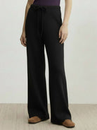 Lightweight wool wide leg pants in neutral color with soft brushed texture and relaxed fit