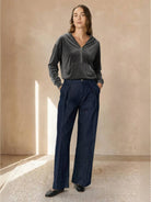 Ultra-soft velvet half-zip hoodie with hood and kangaroo pocket, plush texture, and relaxed fit