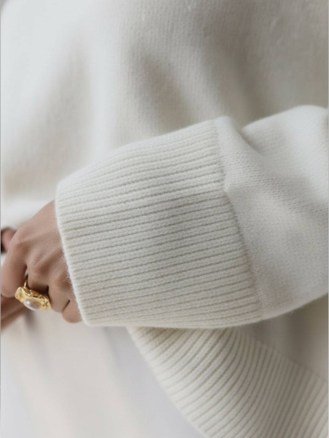 oversized crew neck knit sweater with drop-shoulder sleeves and ribbed cuffs in neutral color