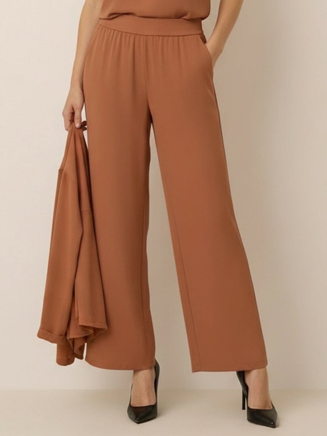 Woman wearing open-front three-piece co-ord with longline cardigan, tank top, and wide-leg trousers in lightweight knit fabric