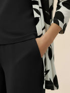 Open-front longline cardigan with three-quarter sleeves, matching wide-leg trousers, and round-neck tank top three-piece co-ord set