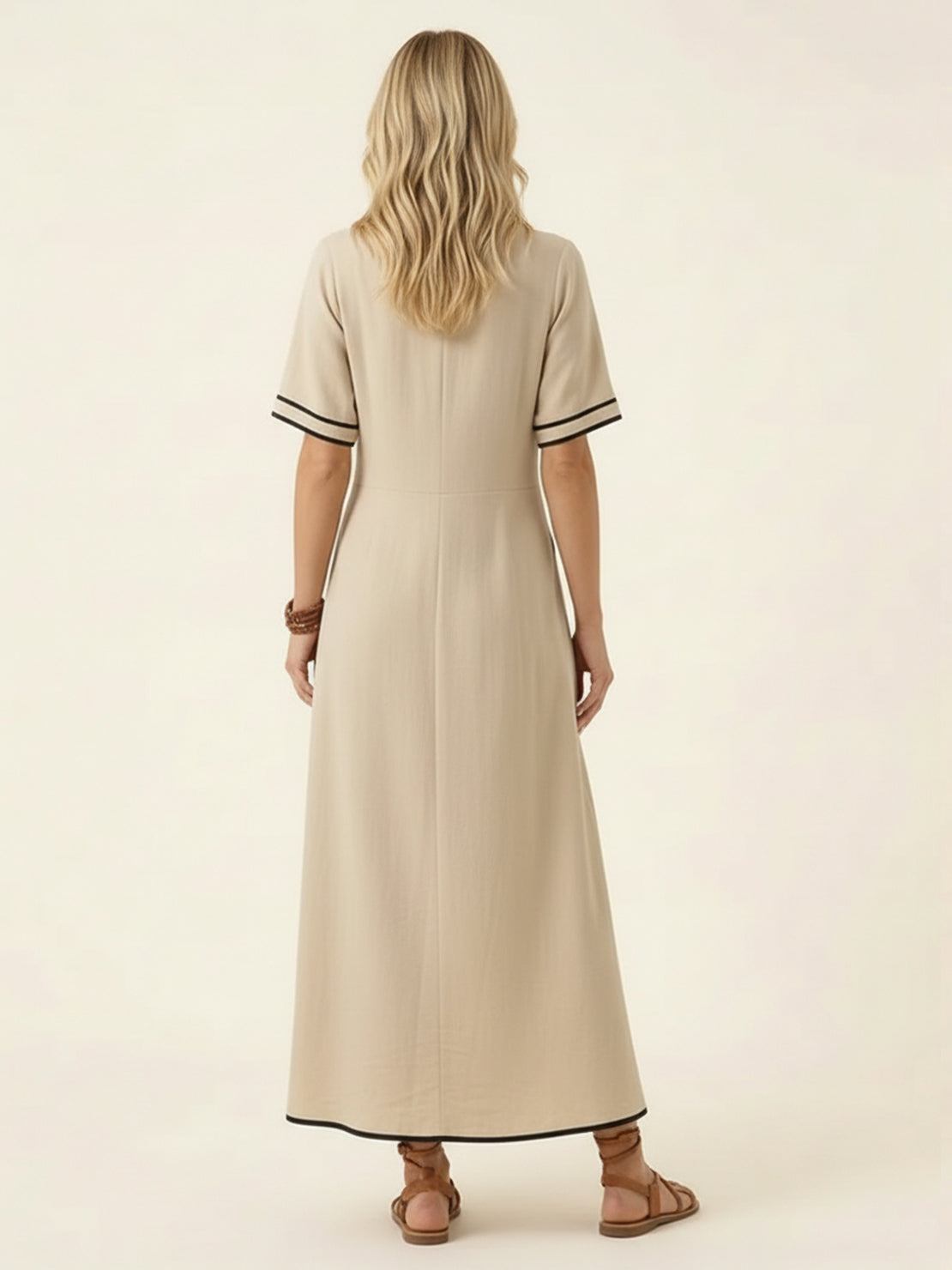Woman wearing a knot-waist maxi dress with V-neckline and flowing skirt