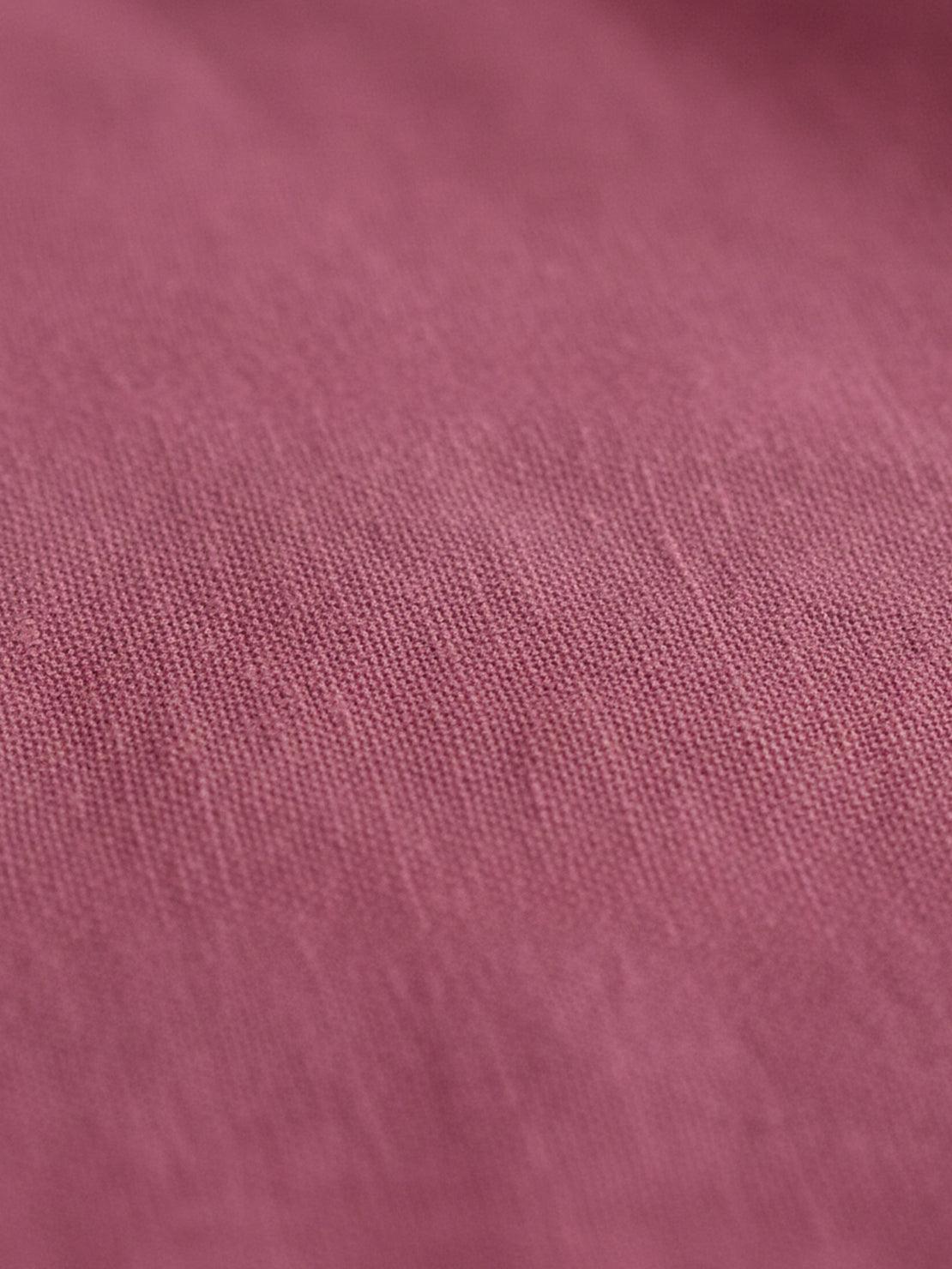 Cotton-linen blazer with notch lapels, two-button front, patch pockets, and relaxed fit.