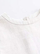 100% cotton-linen sleeveless top with round neckline and button closure at back neck