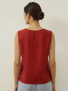 White cotton-linen sleeveless top with round neckline and relaxed A-line fit