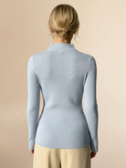 Asymmetric wrap ribbed knit top with diagonal button closure and flared cuffs