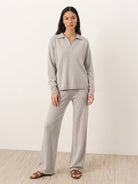 woman wearing oversized polo knit loungewear set with V-neck and straight-leg pants