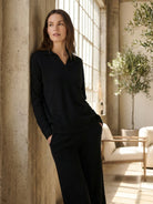 woman wearing oversized polo knit loungewear set with sweater and straight-leg pants