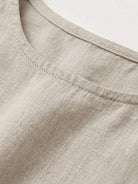 Woman wearing cotton linen sleeveless maxi dress with round neckline and flowing ankle-length silhouette