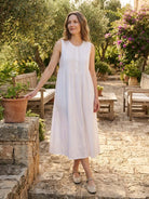 Sleeveless cotton linen pleated midi dress with pintuck bodice and A-line skirt in white and sage colors