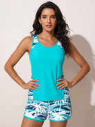 Racerback two-piece tankini set with relaxed fit, hip-length tank, and tropical print swim shorts with pockets and drawstring waistband