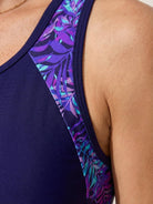 Racerback two-piece tankini set with hip-length racerback tank and mid-thigh swim shorts in tropical print