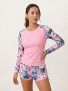 Long-sleeve UV rash guard set with tropical print sleeves and matching swim shorts for sun protection