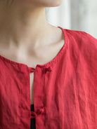 Oversized 100% linen blouse with frog-button closure and collarless neckline