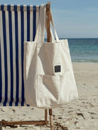 Beige cotton linen canvas shoulder bag with front pocket and comfortable straps, lightweight and spacious for everyday use
