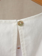 Sleeveless linen lyocell blend dress with relaxed A-line silhouette in white and black colors