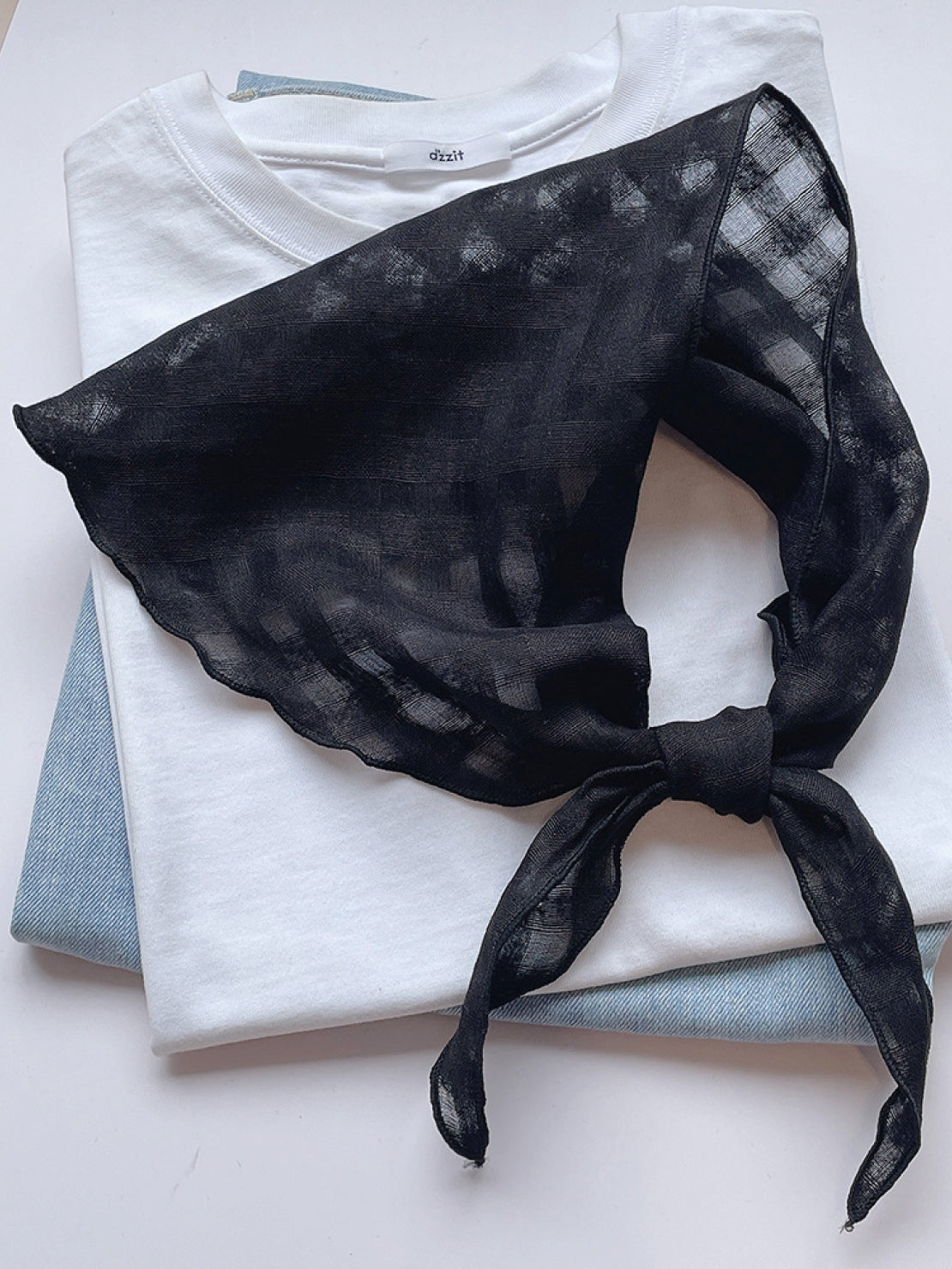 Lightweight 100% linen neck scarf with timeless checkered pattern and natural rolled edges.