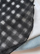Lightweight 100% linen neck scarf with timeless checkered pattern and natural rolled edges
