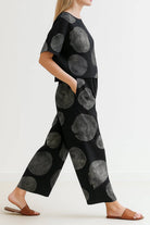Woman wearing Breezy Meadow Two-Piece Set with relaxed top and wide-leg trousers in lightweight fabric