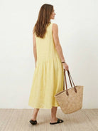 Lightweight cotton-linen summer midi dress with tiered skirt and relaxed drop-waist silhouette in soft neutral color