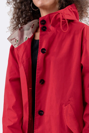 Red water resistant oversized hooded windbreaker jacket with black buttons and floral inner lining