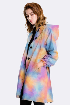 Water resistant oversized windbreaker rain jacket with colorful gradient design and hood, modeled by woman