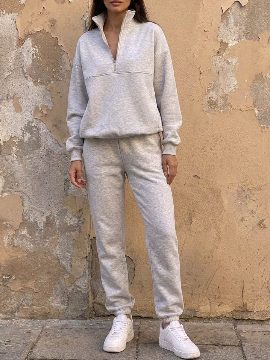 Cotton-blended two-piece tracksuit with zip-front top and straight-leg pants on mannequin