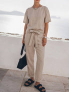 Model wearing a breathable cotton linen set with relaxed monochrome top and straight-leg pants