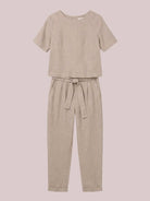 Woman wearing relaxed fit cotton linen set with short-sleeve top and straight-leg pants in monochrome tones