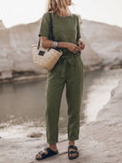 Woman wearing a relaxed cotton linen set with short-sleeve top and straight-leg pants in monochrome tones