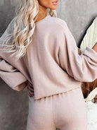 Woman wearing beige round neck loose fit cozy two-piece set with long sleeves and wide-leg pants