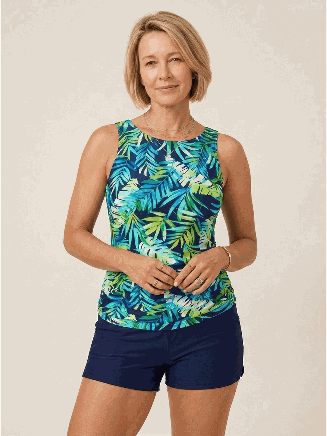 woman wearing high-neck ruched tankini set with gathered sides and swim skirt bottom at the beach