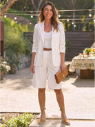 Woman wearing a tailored blazer and high-waisted shorts two-piece set in a polished monochrome style