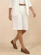 Woman wearing a polished blazer and high-waisted shorts two-piece set in a monochrome outfit