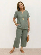 Woman wearing breezy cotton blend two-piece set with short-sleeved shirt and elastic waist pants