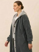 Woman wearing cozy oversized sherpa long coat with button closure and hooded sweatshirt underneath Everyday Wear Oversized Coat