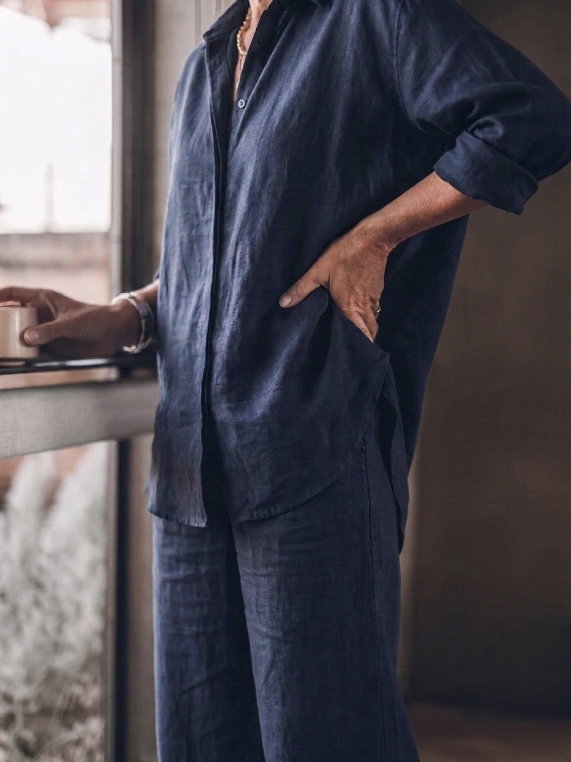 Woman wearing an oversized 100% cotton shirt and wide-leg pants co-ord set in a relaxed, breathable style