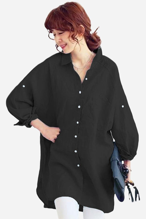 Woman wearing black oversized linen shirt with loose sleeves and button details