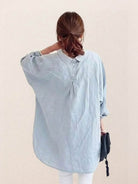 Oversized linen shirt in white with relaxed fit and back button detailing