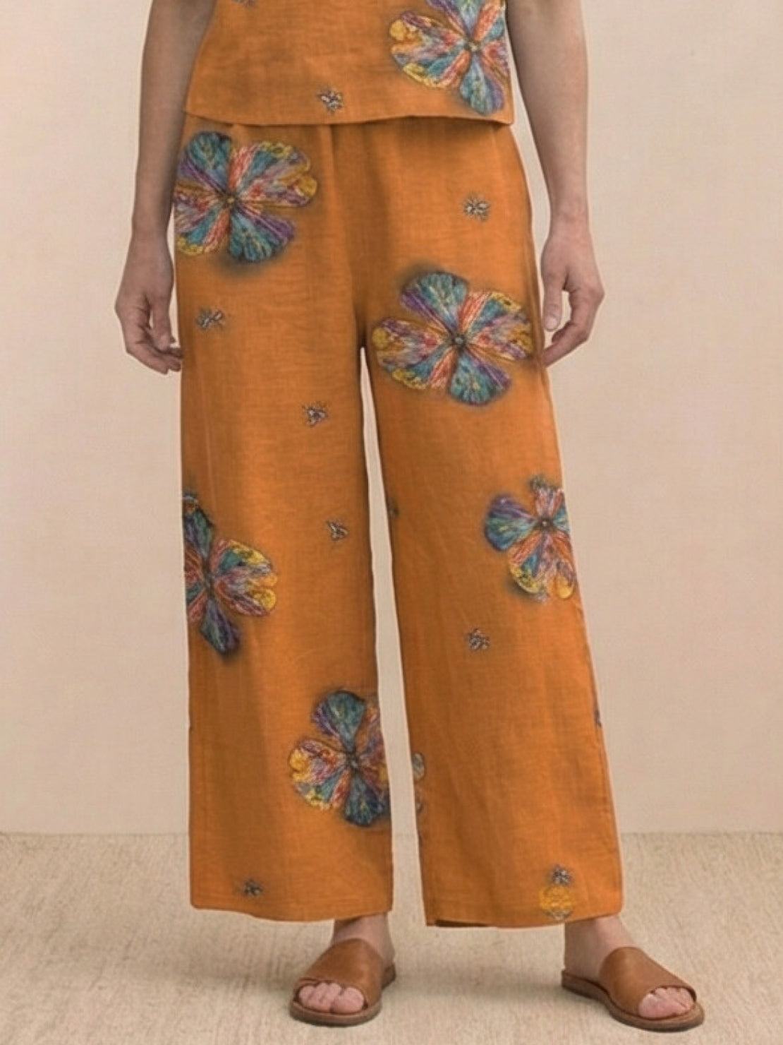 Woman wearing a loose fit co-ord set with a soft-tailored top and wide-leg bottoms in a relaxed, breathable fabric.