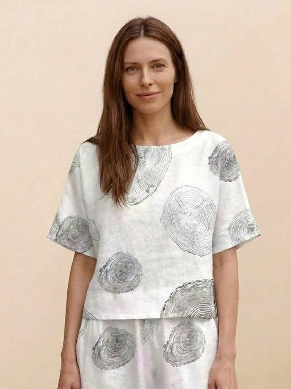 Woman wearing floral print loose fit co-ord set with wide short sleeves and wide-leg bottoms