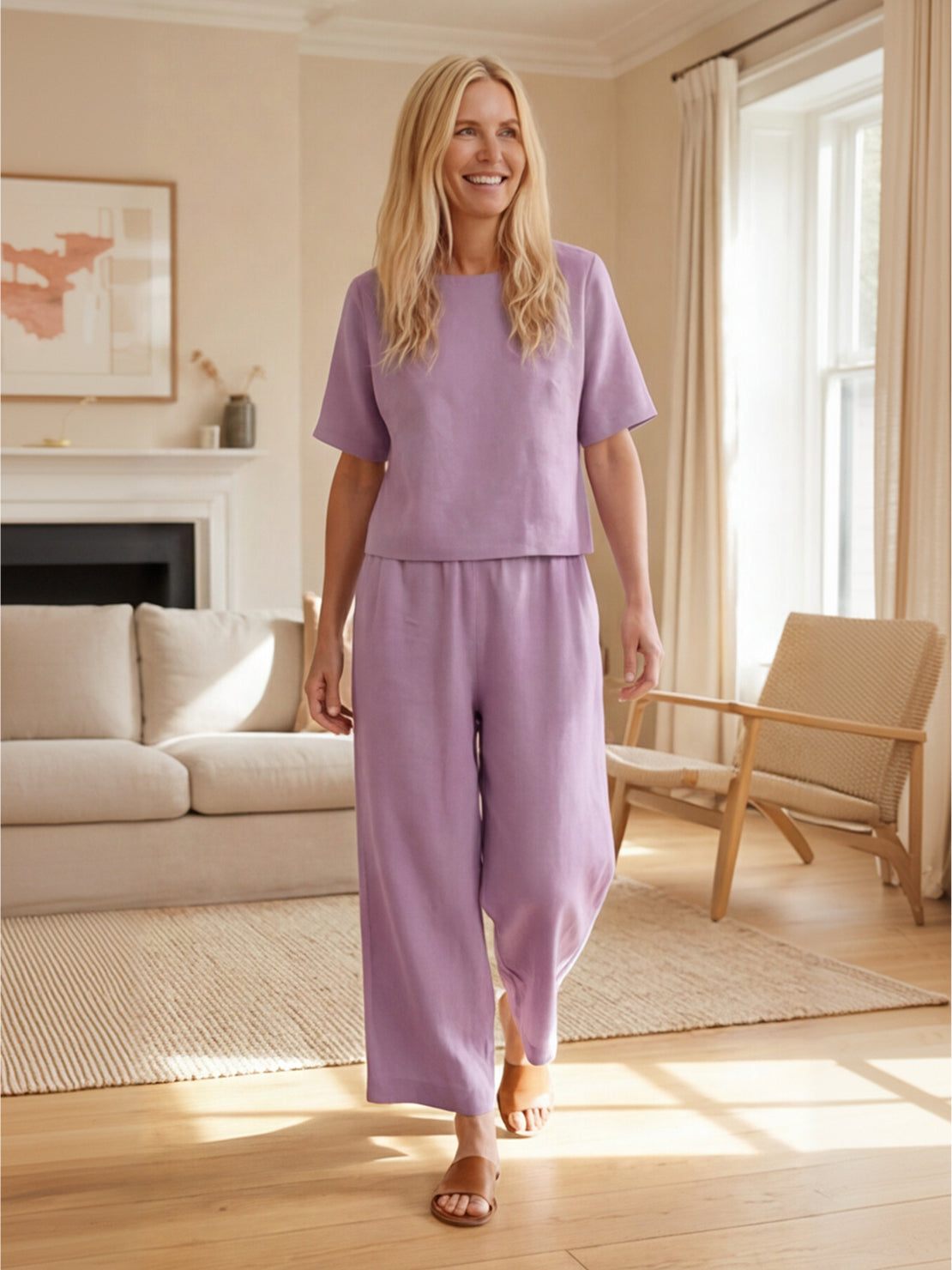 Woman wearing loose fit co-ord set with soft-tailored top and wide-leg bottoms in a relaxed summer style