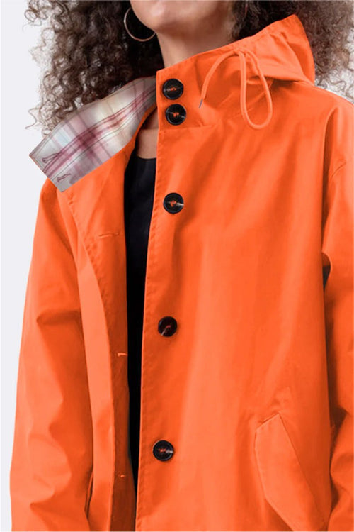 Orange oversized Rain Couture Windbreaker jacket with hood and button closure, water-resistant polyester fabric