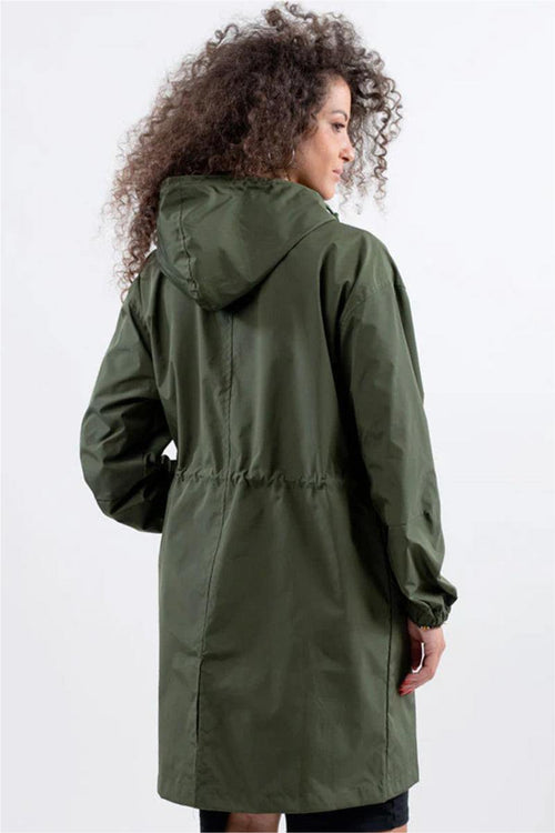 Woman wearing oversized olive green Rain Couture Windbreaker with hood, back view