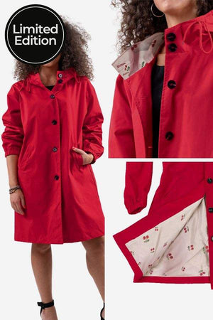 Limited edition red Rain Couture Windbreaker with oversized fit, water-resistant polyester, adjustable hood, button closure, and floral inner lining.